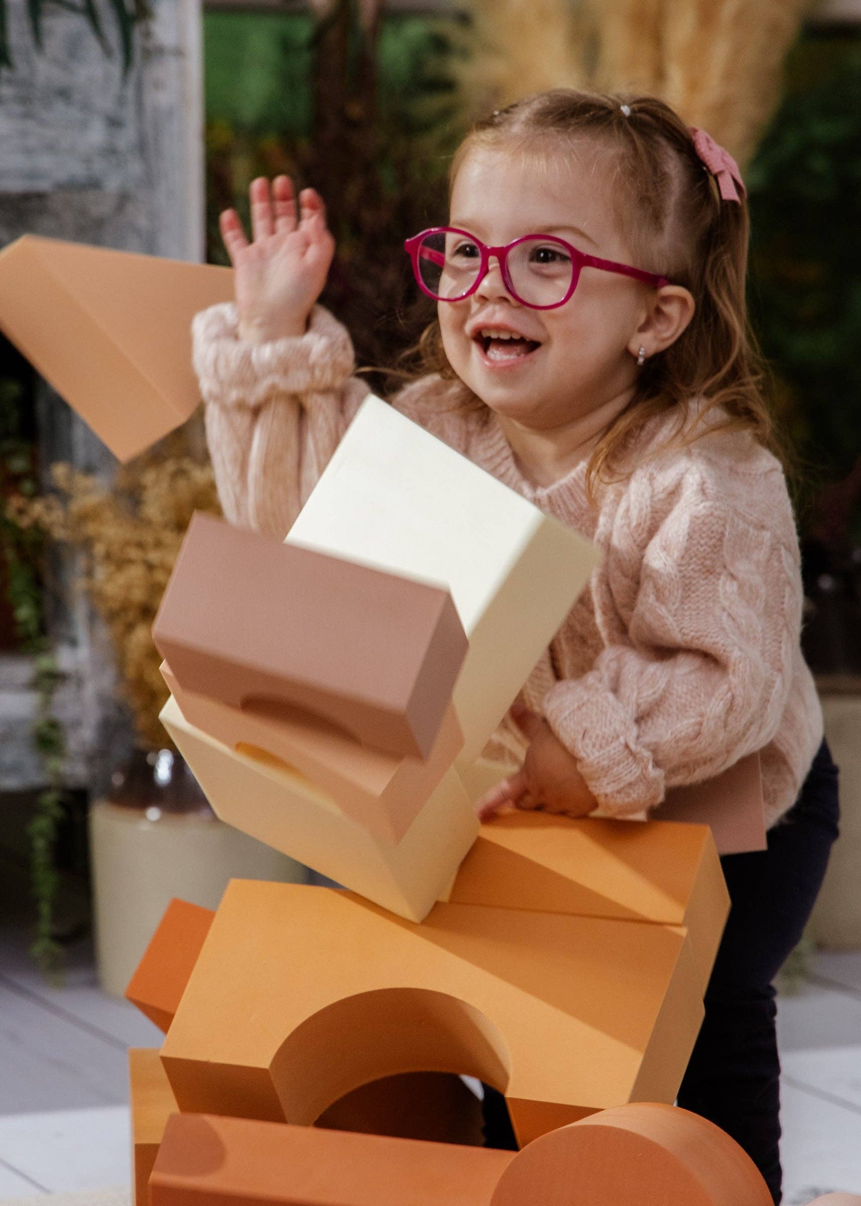Child playing with foam building blocks outdoors