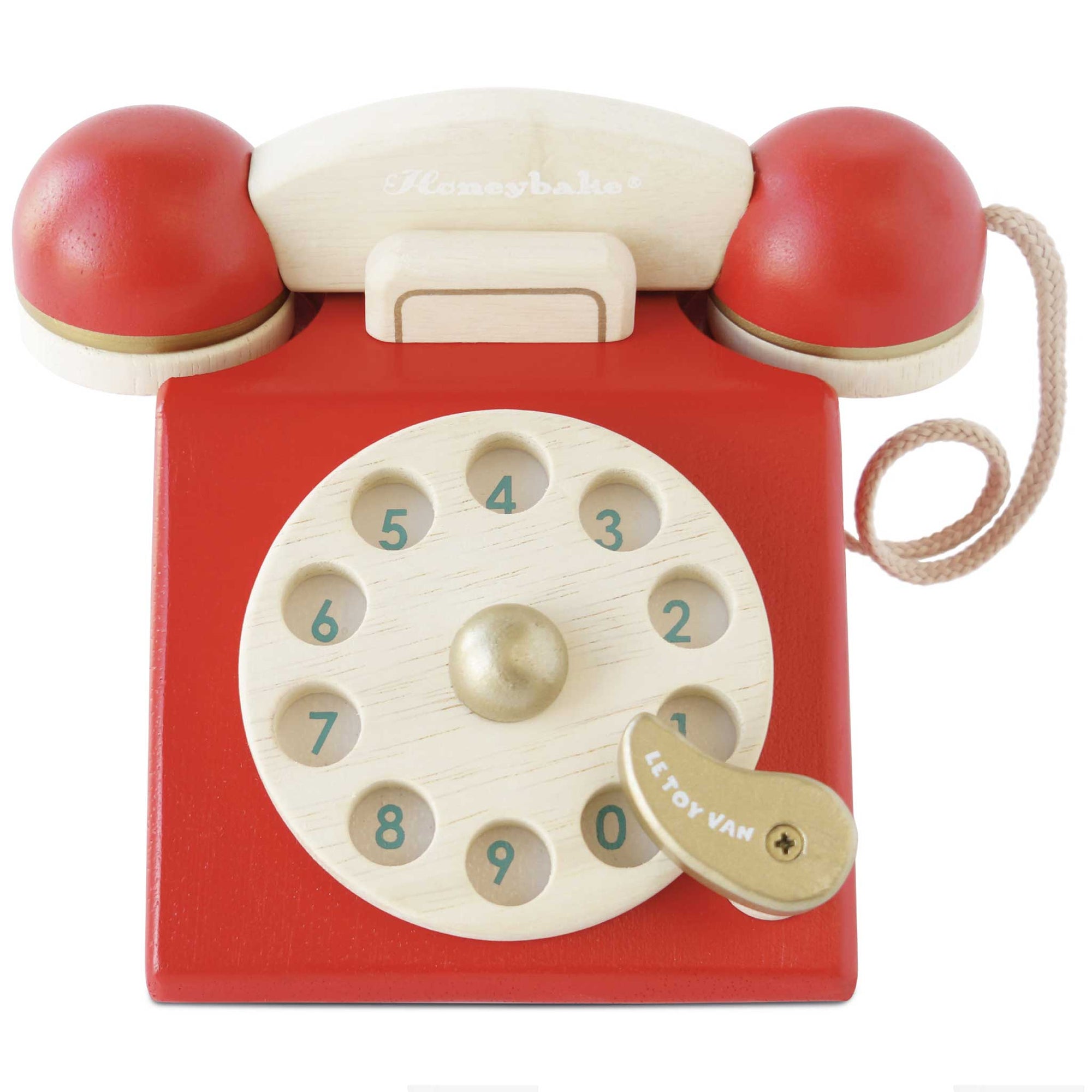 Red toy telephone with wooden rotary dial on a white background