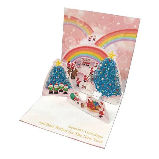 Pop-up Christmas card with Santa Claus, reindeer, and trees on a pink background.
