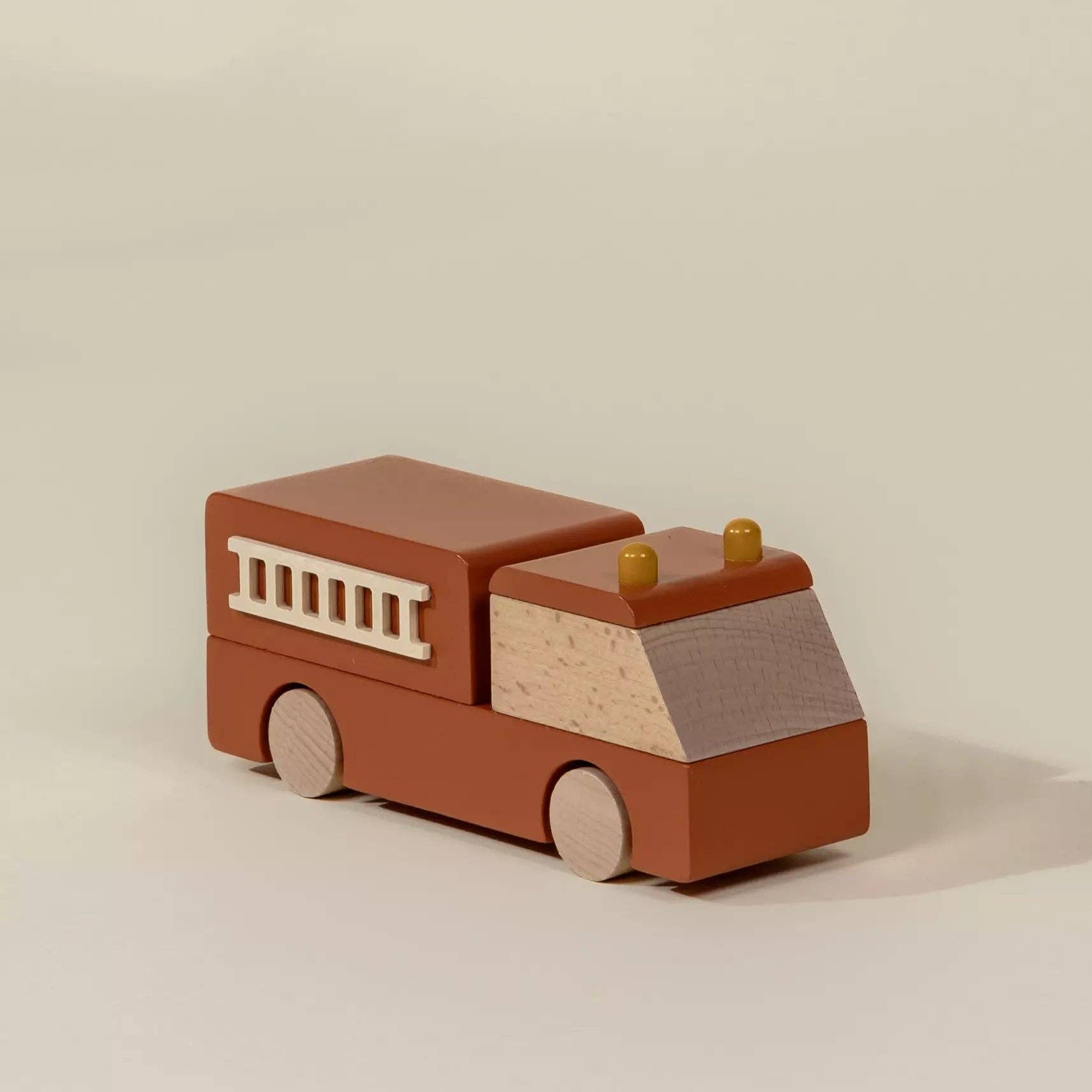 Wooden toy fire truck on a beige background