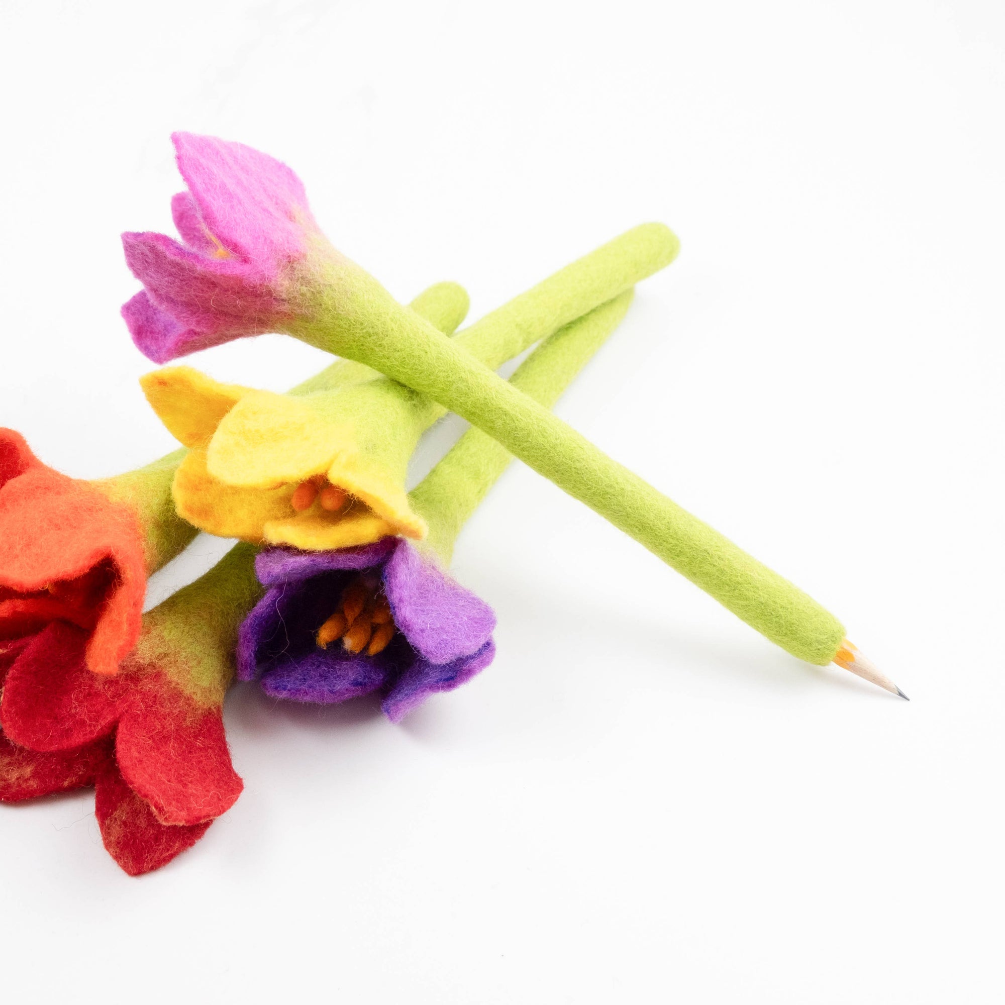 Colorful felt flowers on a white background
