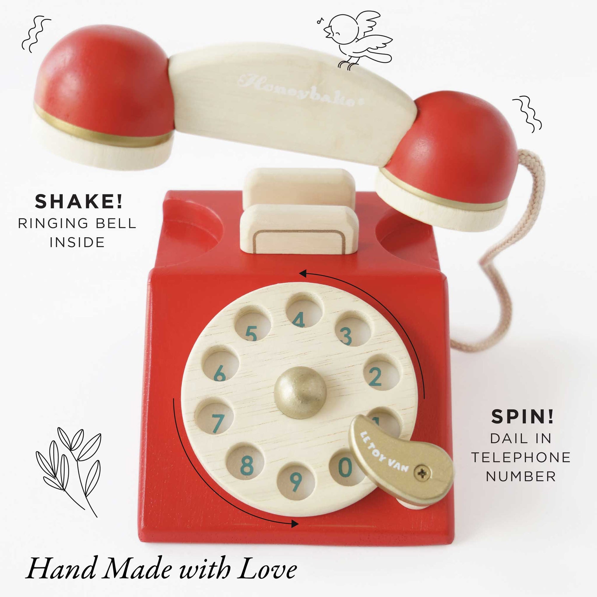 Red toy telephone with a rotary dial on a white background