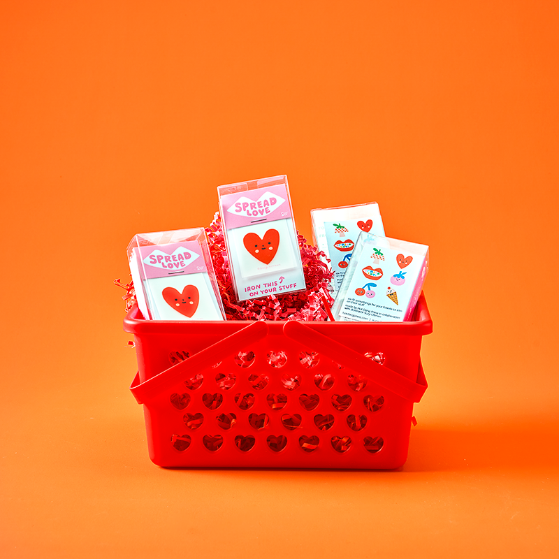 Red basket with Valentine's Day cards on an orange background