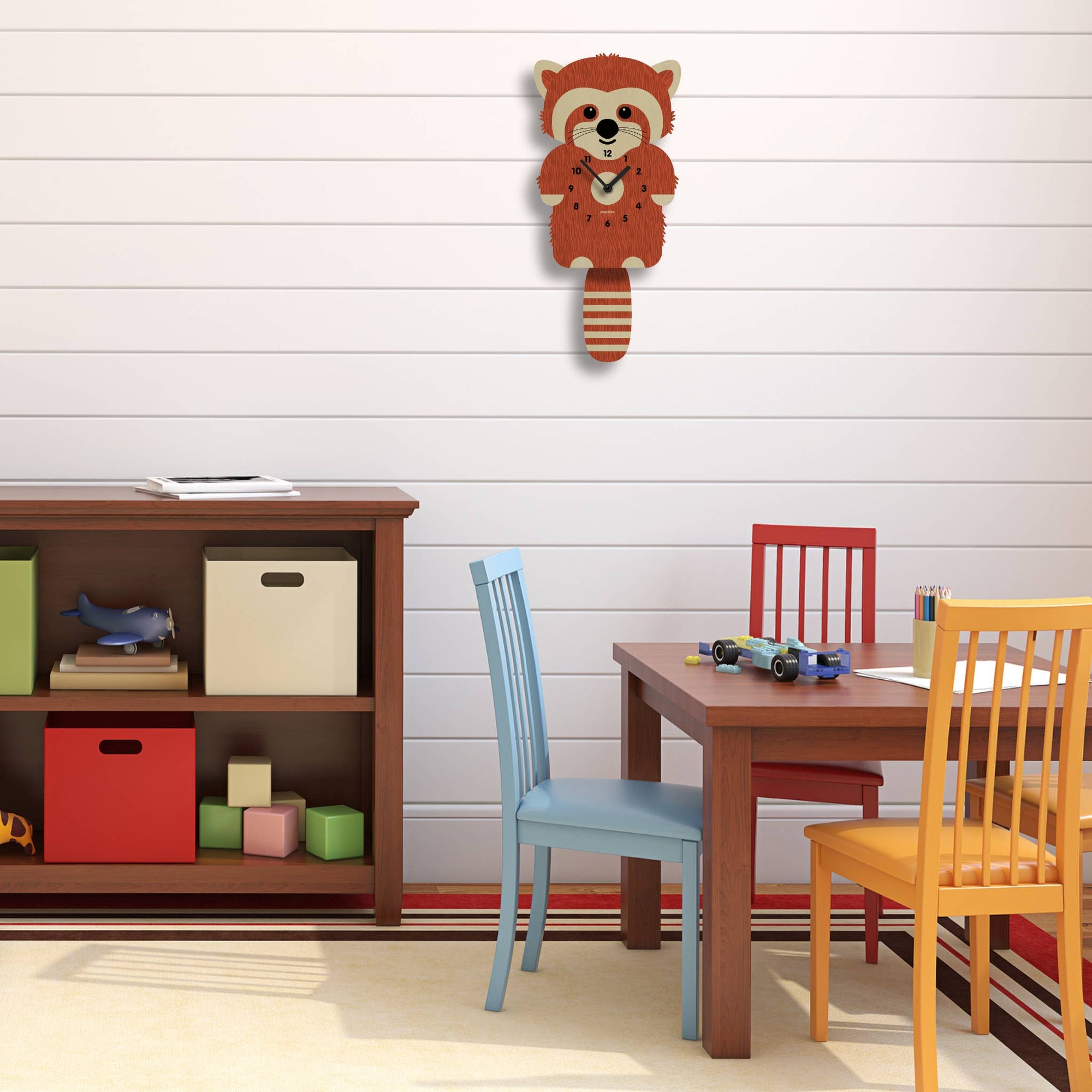 Children's room with wooden wall hook shaped like a raccoon, bookshelf, and table with chairs.