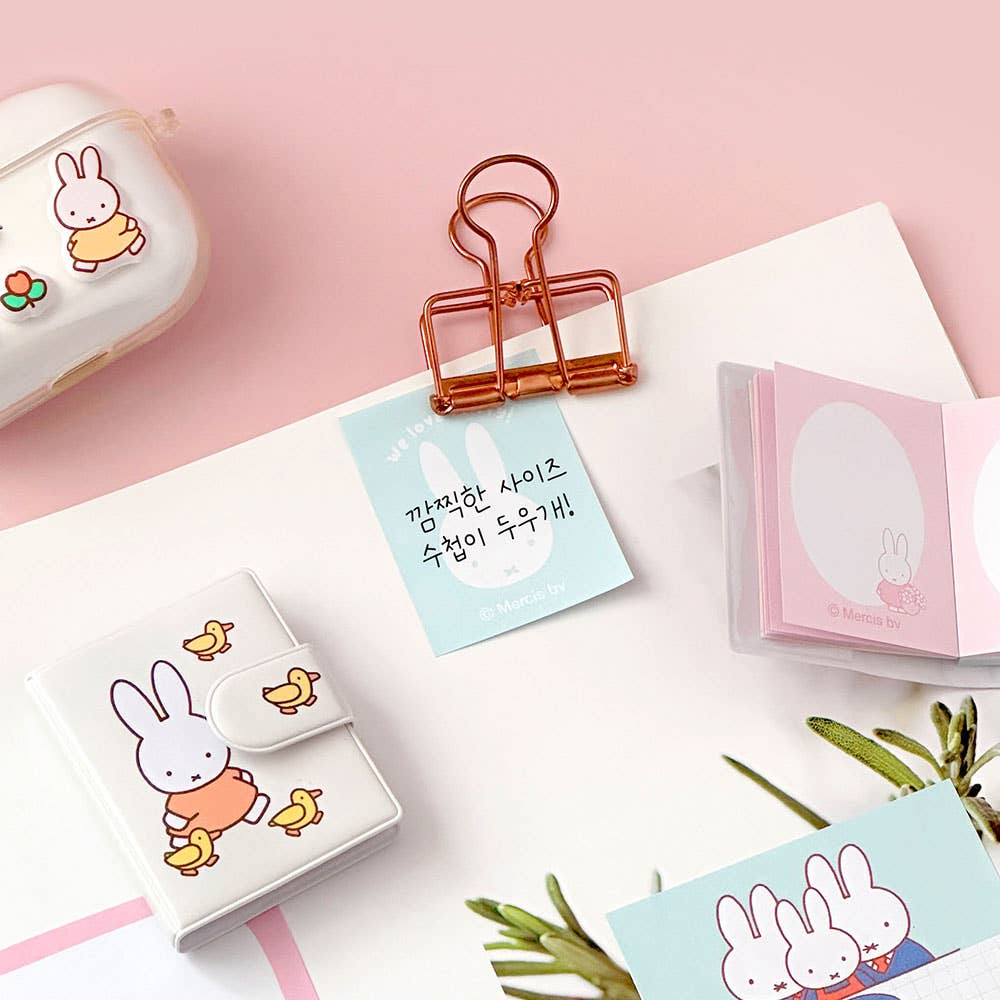 Kawaii stationery items with rabbit designs on a pink background