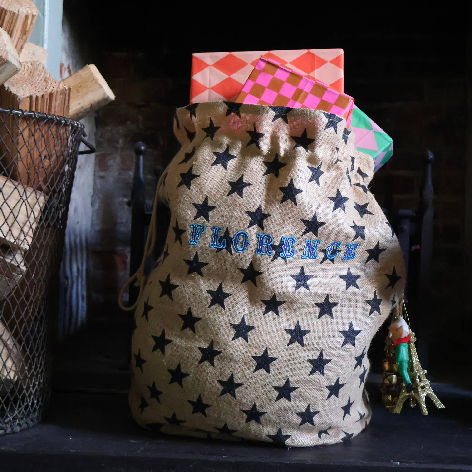 Star-patterned bag with 'FLORENCE' embroidered on it, placed against a dark background.
