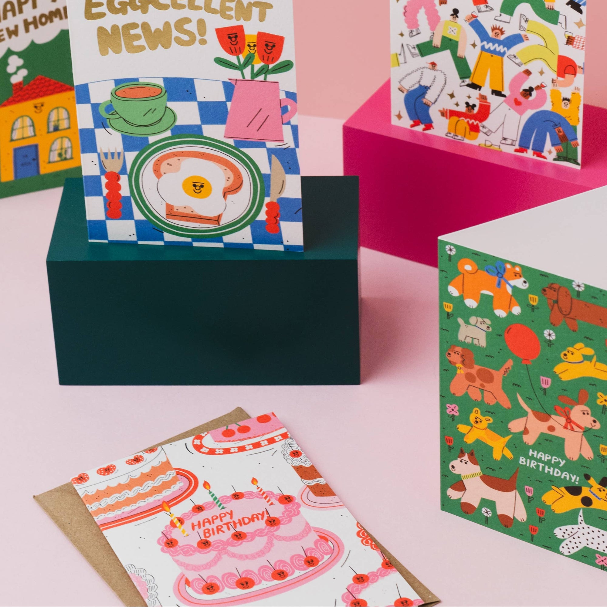 Collection of colorful greeting cards on a pink background