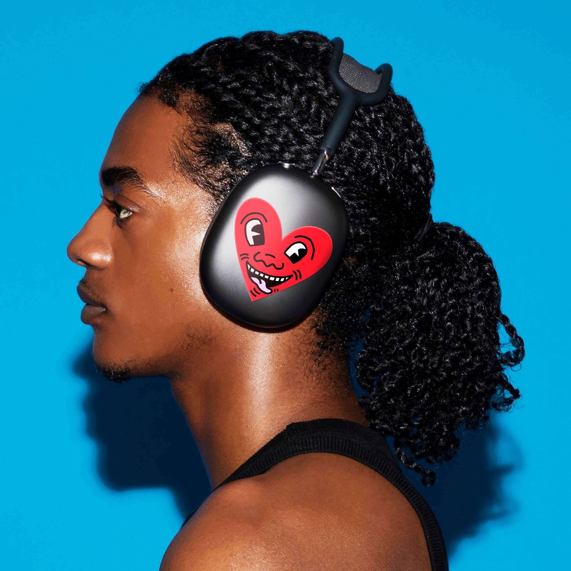 Person wearing headphones with a heart design on a blue background