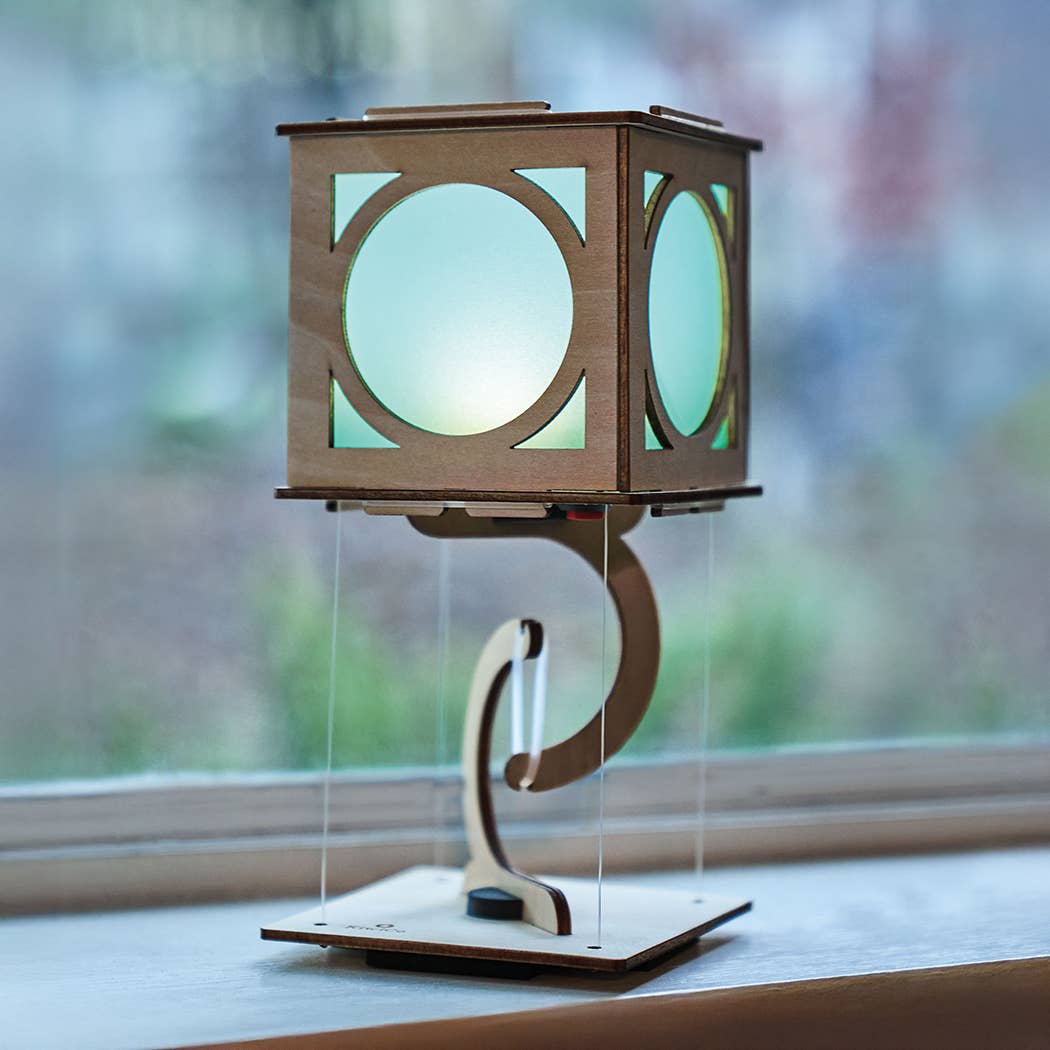 Wooden lantern with a light inside on a windowsill