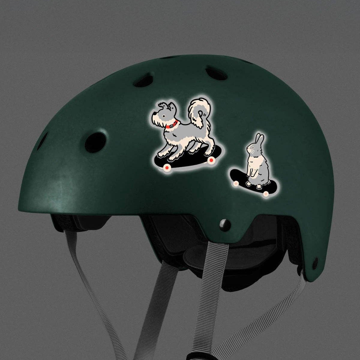 Green helmet with cartoon stickers on a gray background