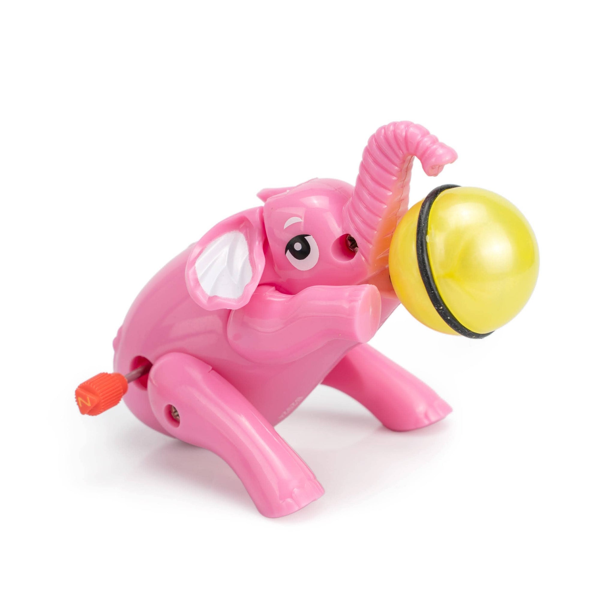 Pink elephant toy with a yellow ball on a white background