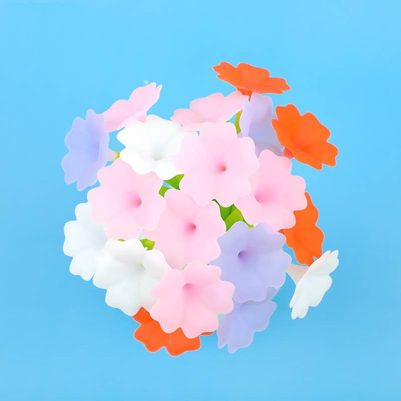 Colorful artificial flowers on a blue background