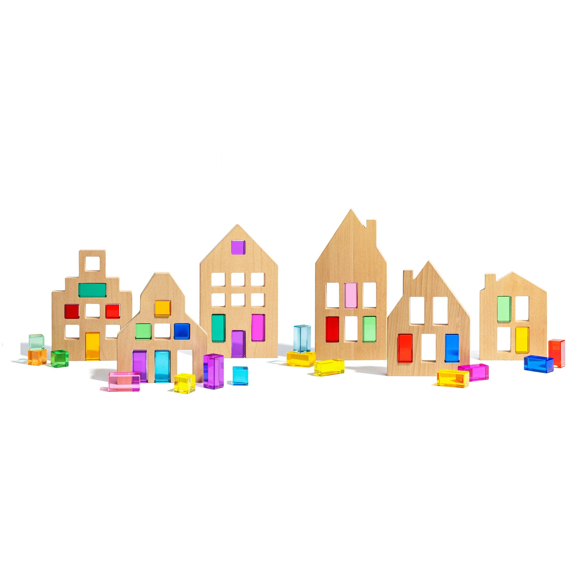 Set of wooden toy houses with colorful windows on a white background