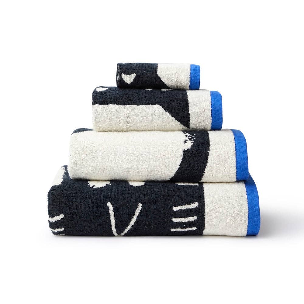 Stack of black, white, and blue patterned towels on a white background