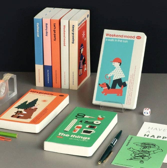 Collection of books with colorful covers on a gray surface