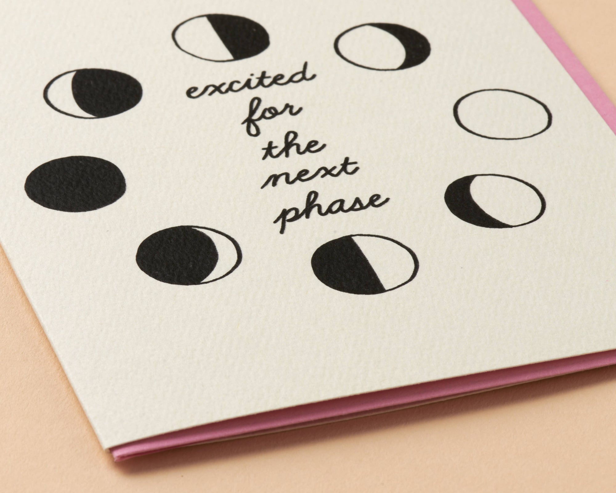card with moon phase illustrations and text 'excited for the next phase' on a beige background