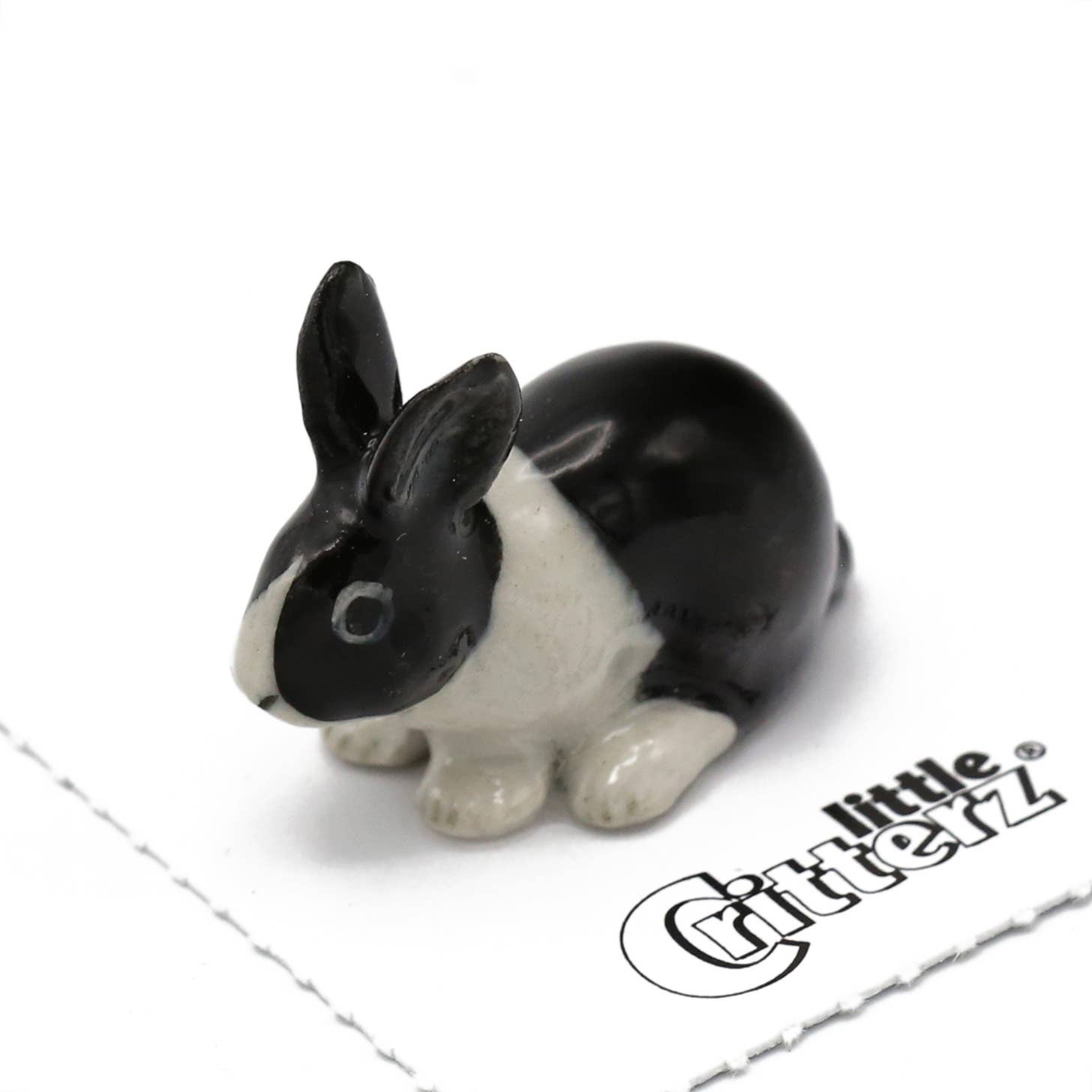 Black and white rabbit figurine with 'Little Critterz' branding on a white background