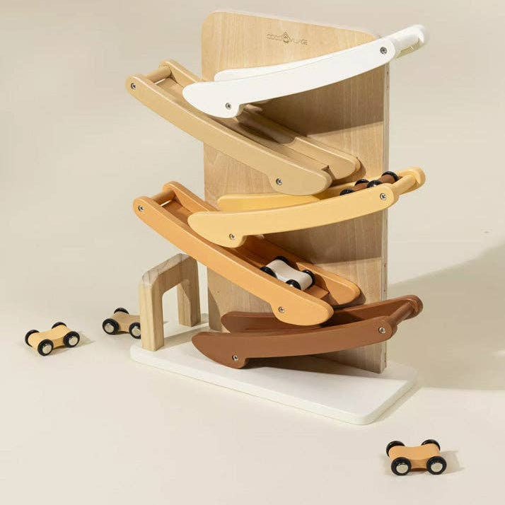 Wooden toy track with cars on a beige background