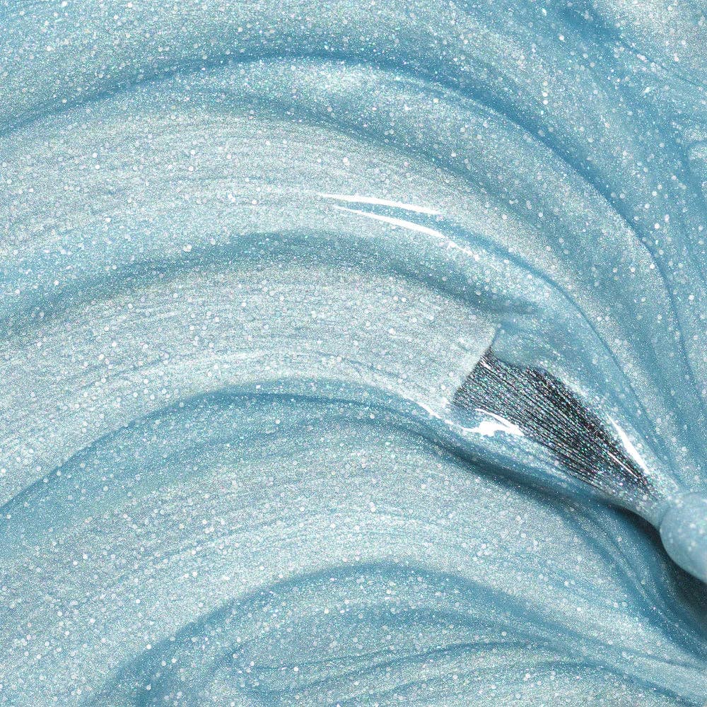 Close-up of blue glittery slime with a tool inside