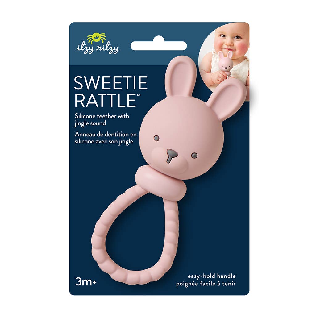 Pink bunny rattle with packaging on a white background