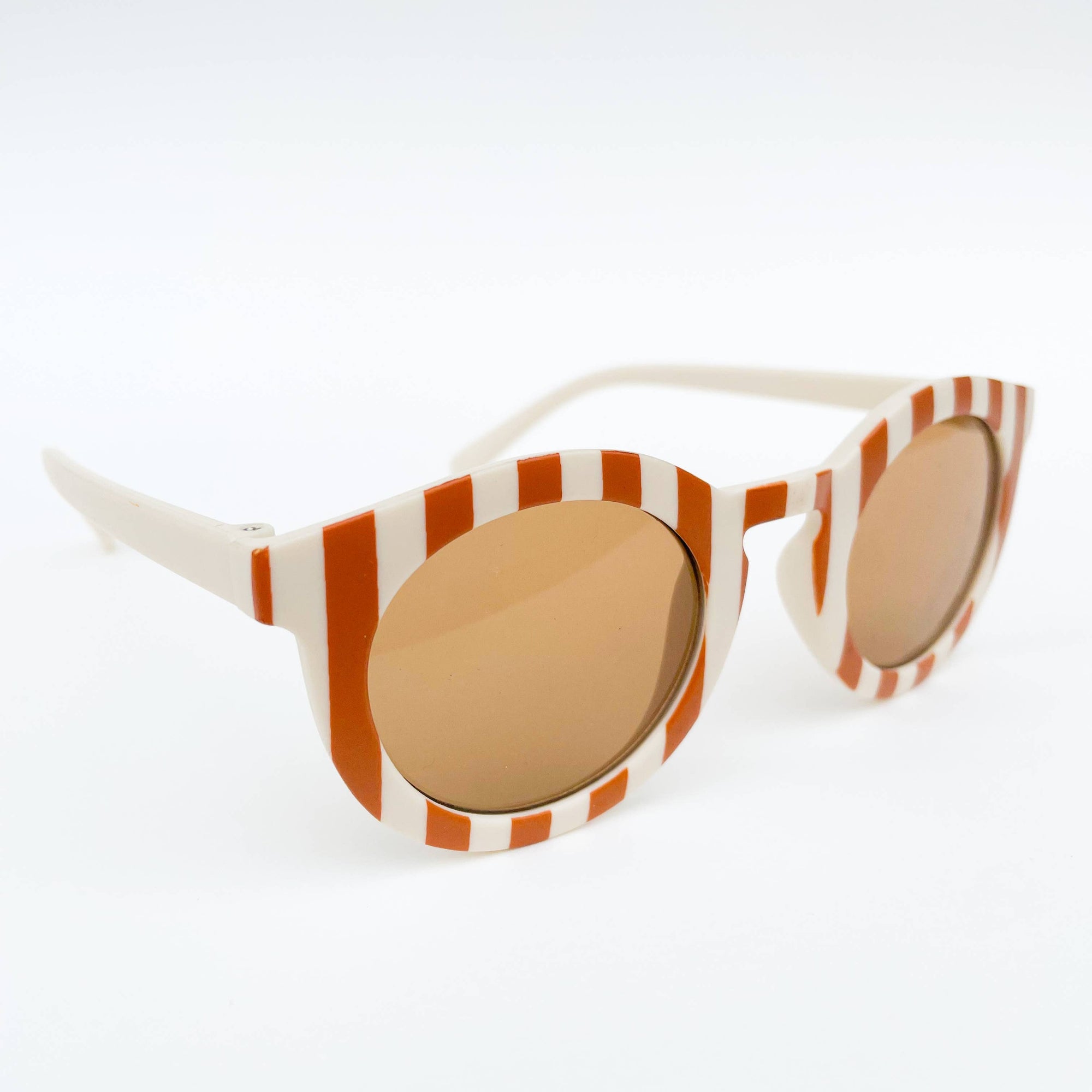 Sunglasses with orange and white striped frame on a white background