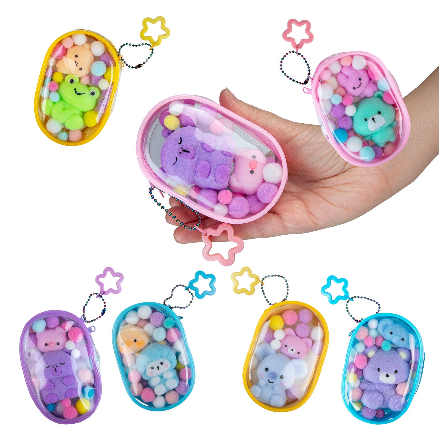 Colorful keychains with animal designs held by a hand on a white background