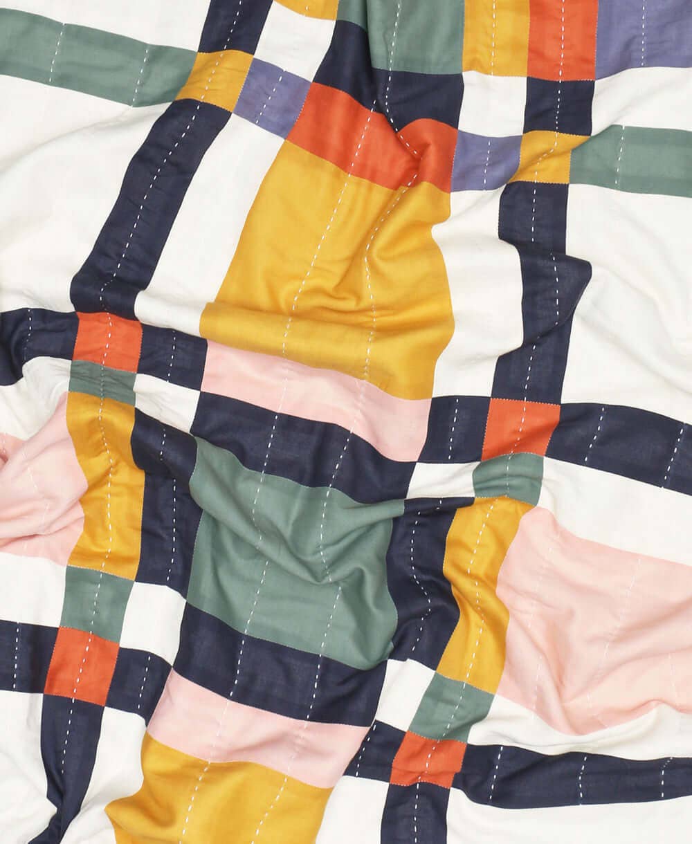Colorful quilt with a patchwork pattern on a white background