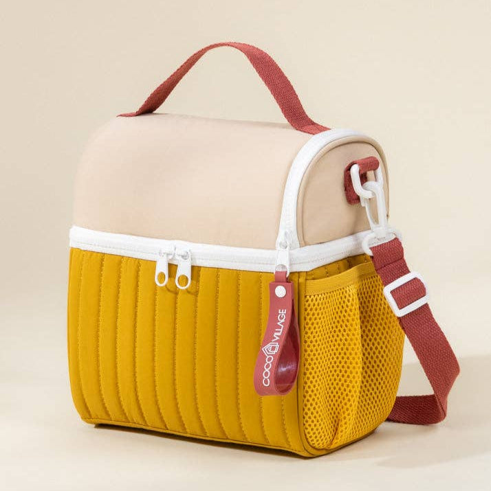 Two-toned bag with beige top and yellow bottom on a beige background