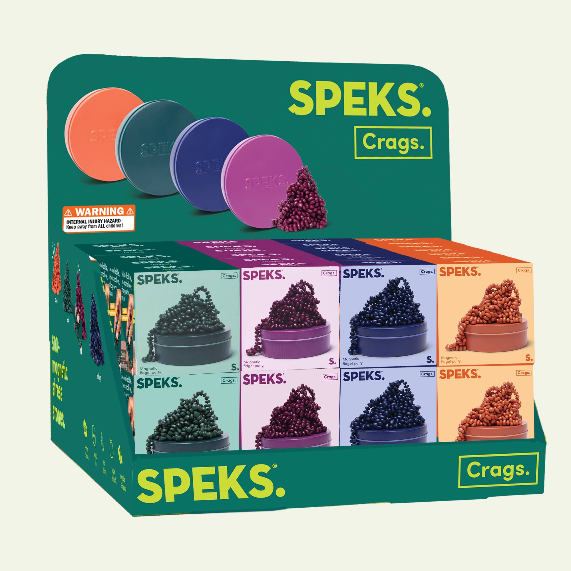 Speks Crags product packaging with colorful containers and warning label on a green background