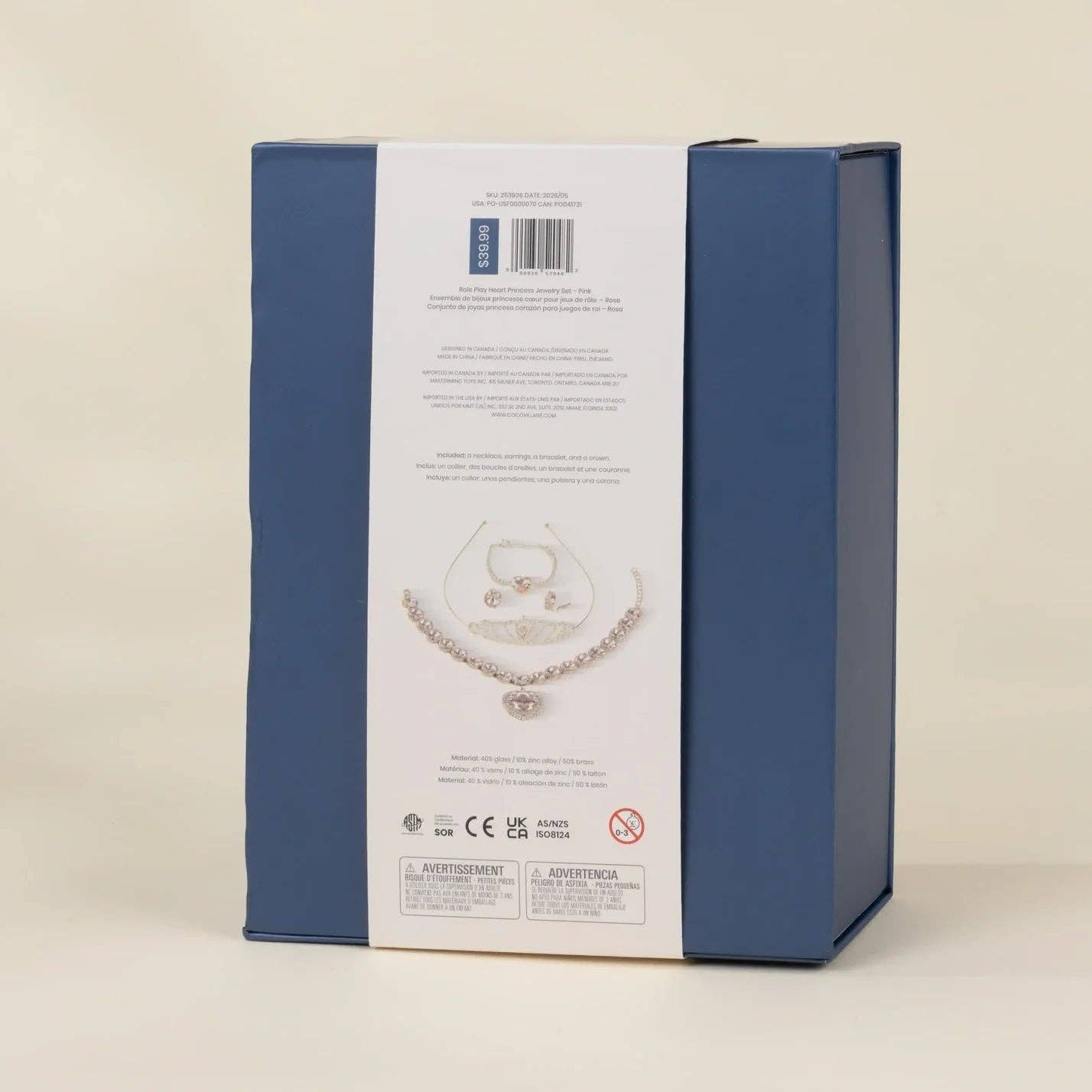 The back of a blue jewelry gift box with a white paper insert showing product details and a necklace illustration, photographed on a light beige background.