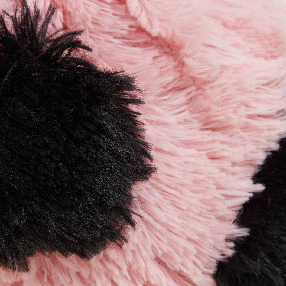 Close-up of pink and black fluffy fabric with a pom-pom.