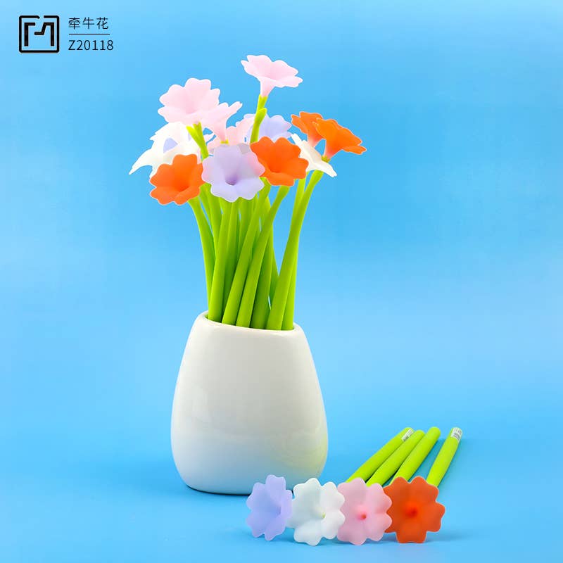 Colorful artificial flowers in a white vase on a blue background