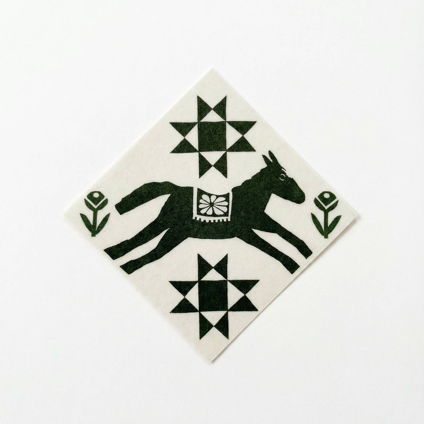 Decorative tile with a black horse design on a white background