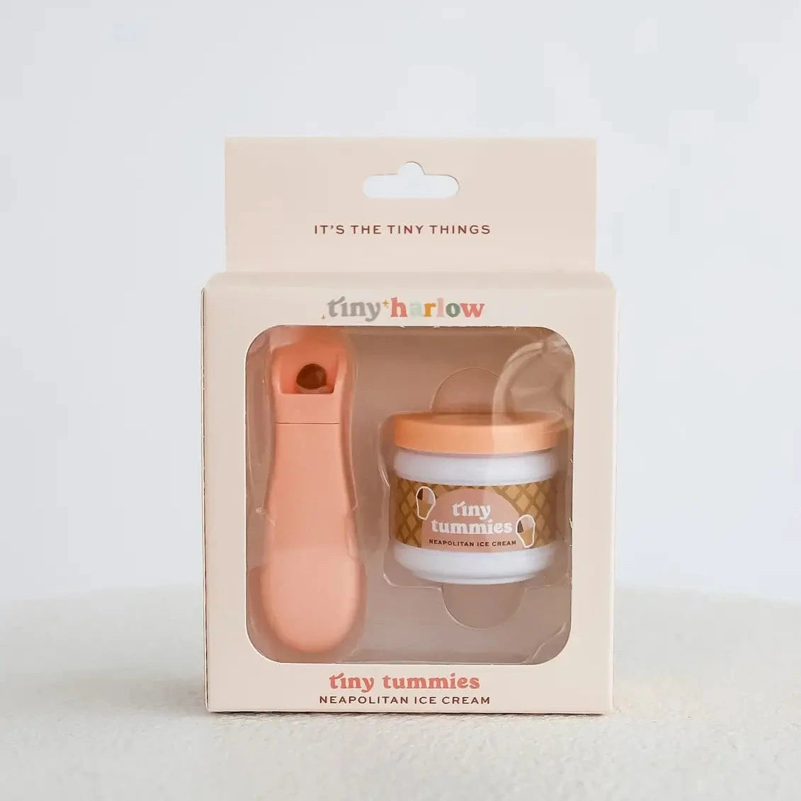 Product packaging with a jar and spoon on a light background