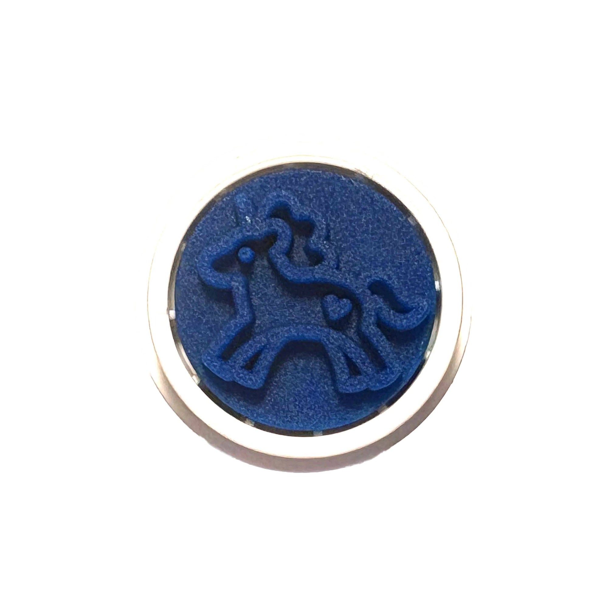 Blue circular object with a silver border on a white background