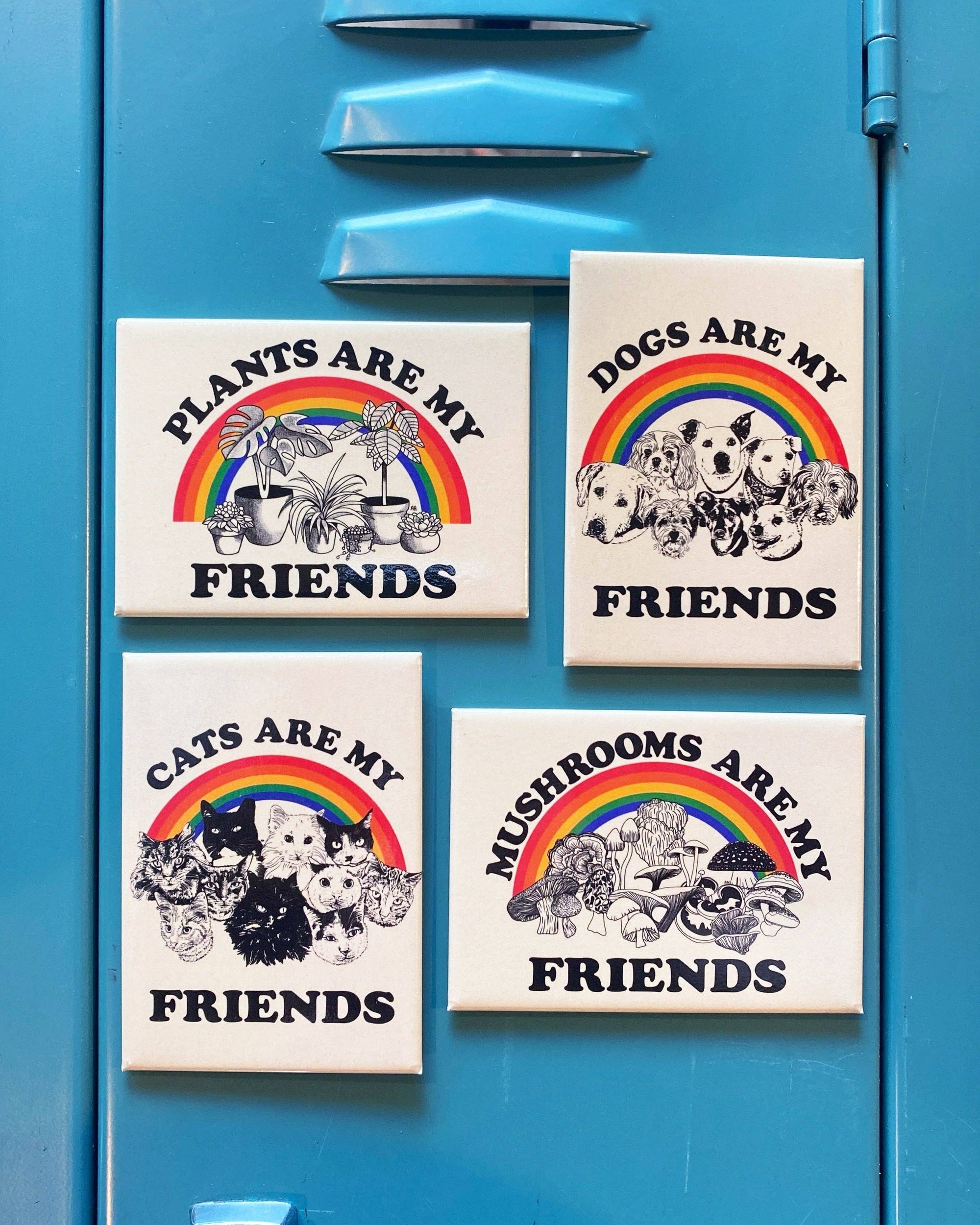 Four signs with animal-themed messages and rainbows on a blue locker.