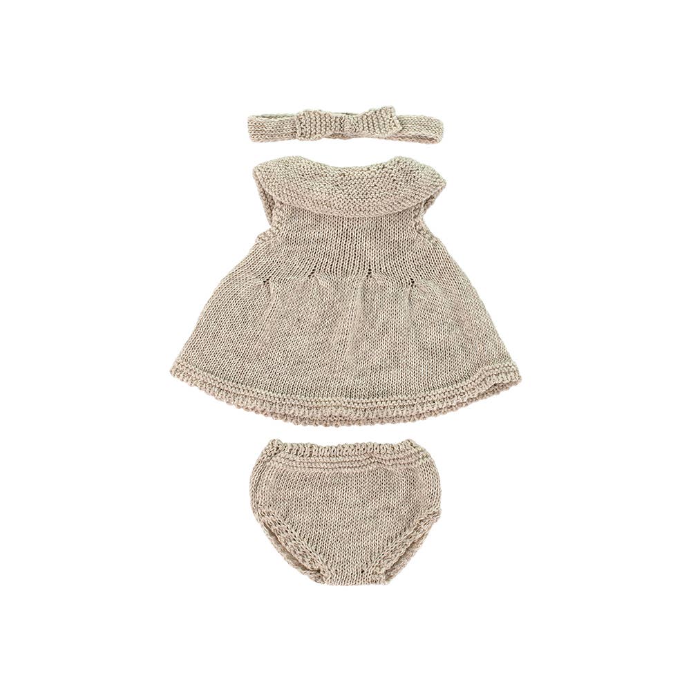 Knitted doll's dress, bloomers, and headband set on a white background