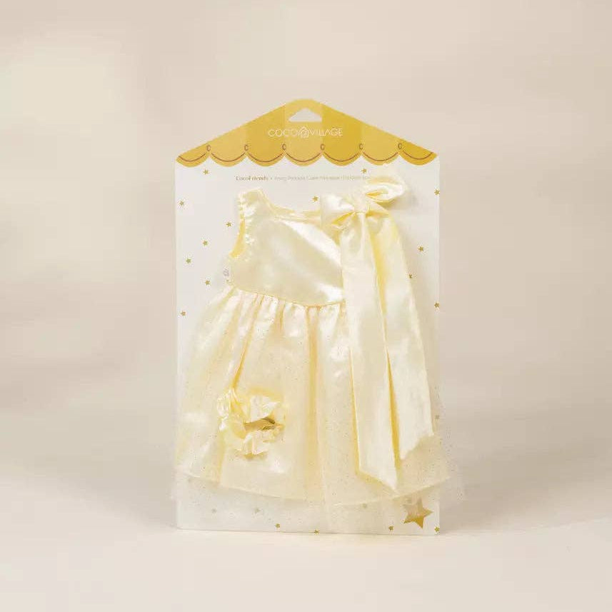 Packaged doll dress with yellow bow on a beige background