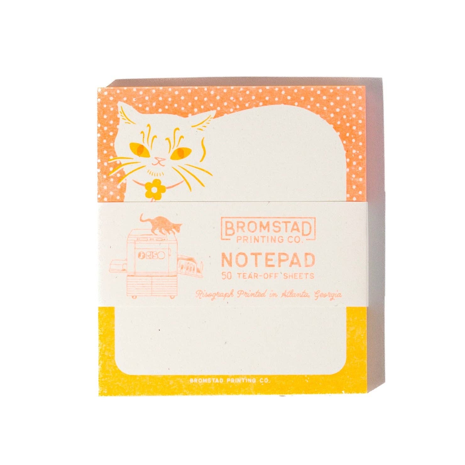 A Bromstad Printing Co. notepad with a retro design, featuring an orange and white polka-dot cat illustration and a yellow bus graphic, on a clean white background.