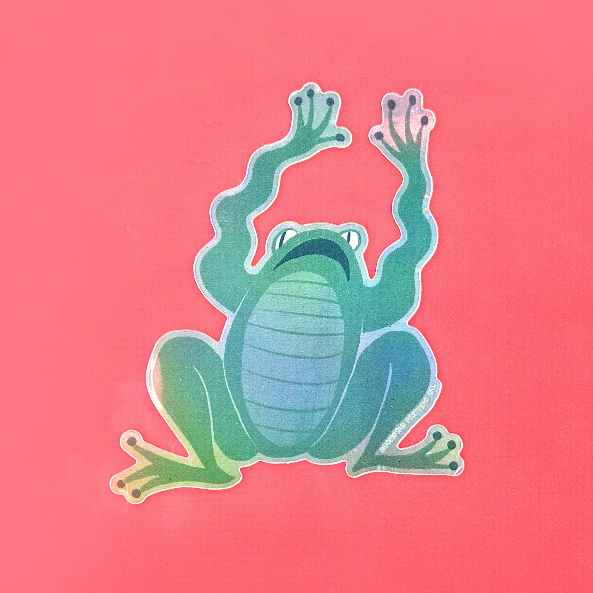 Green frog sticker on a pink background