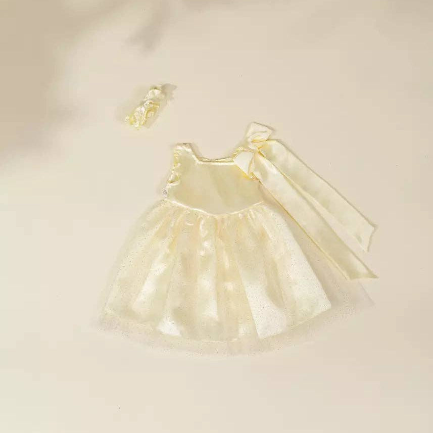 Cream-colored dress with matching headband on a light beige background