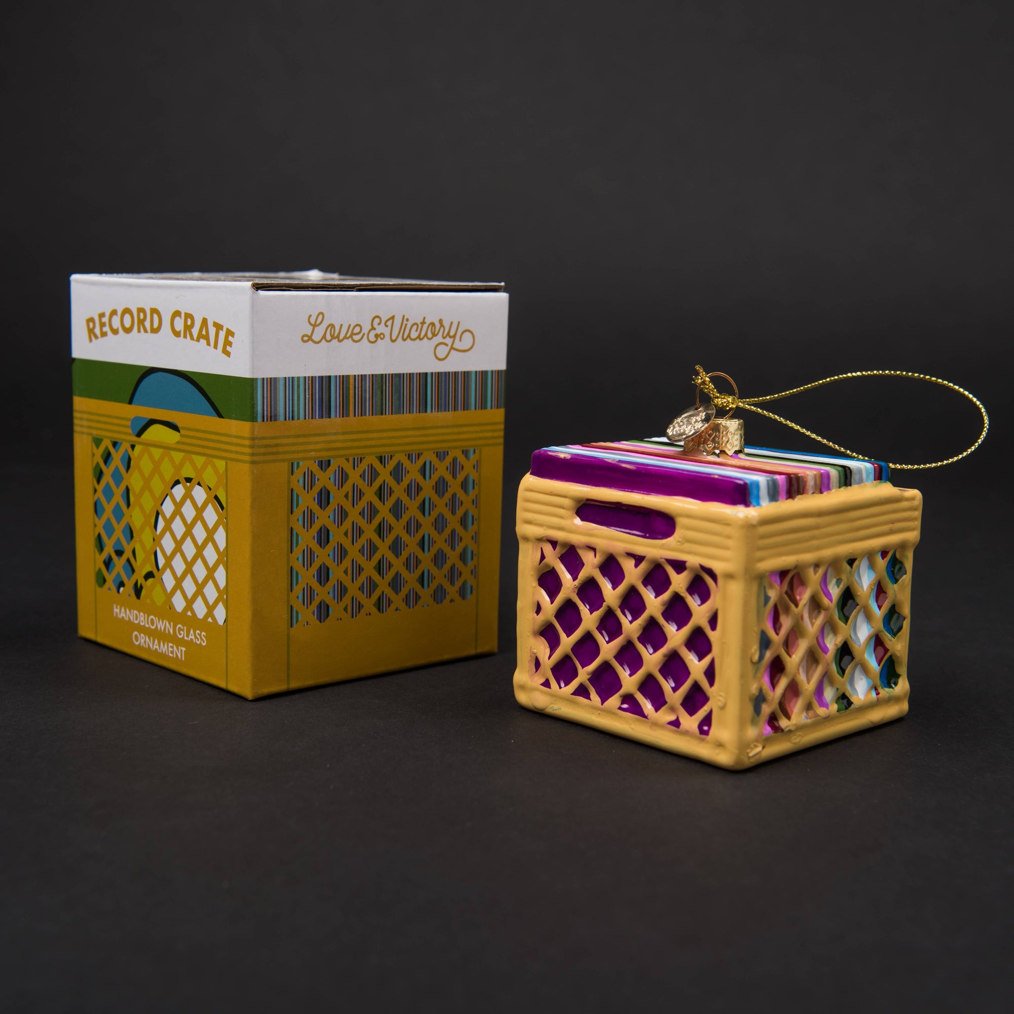 Decorative record crate ornament with packaging on a dark background