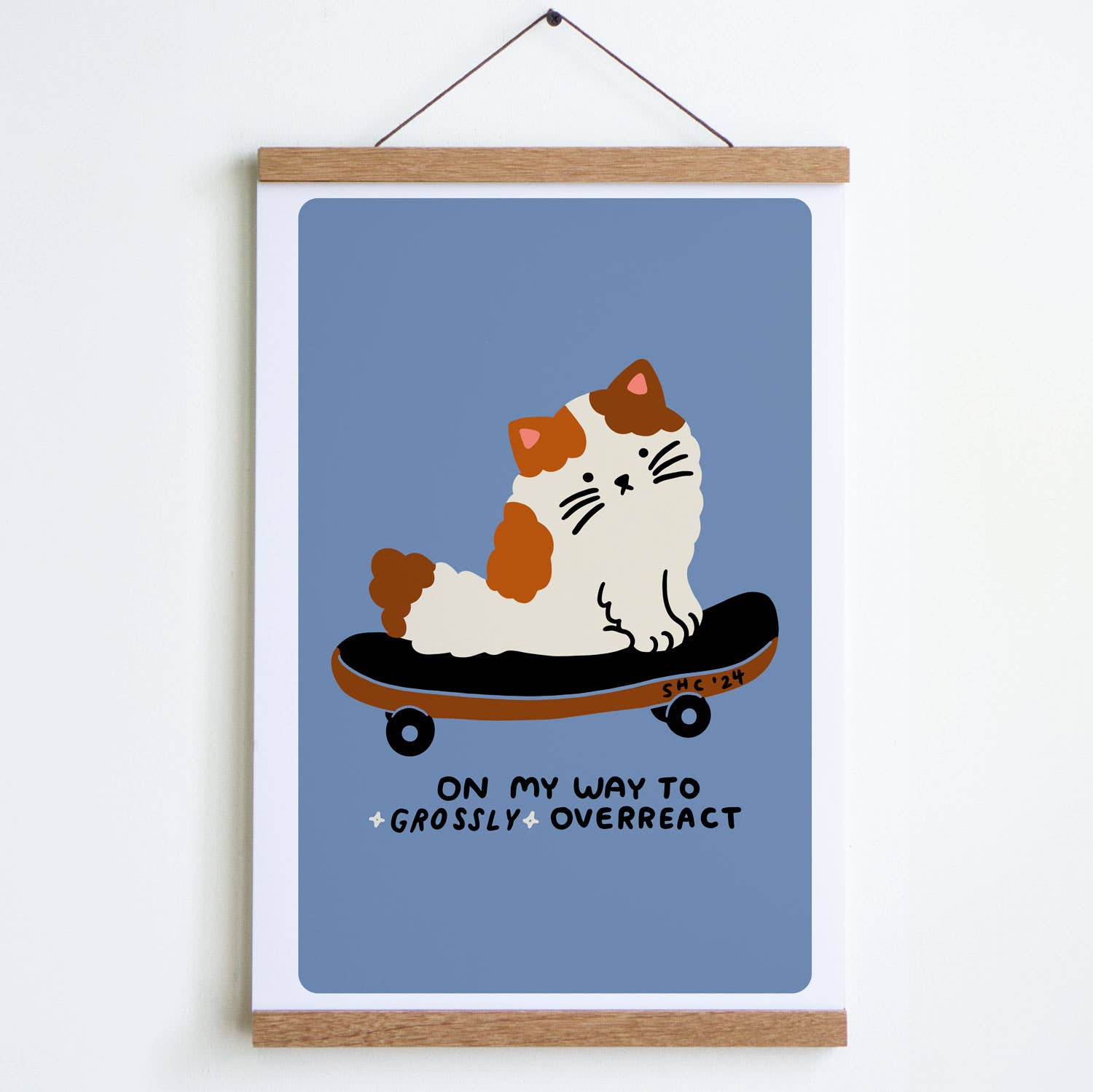 Framed poster with a cat on a skateboard illustration and text on a blue background