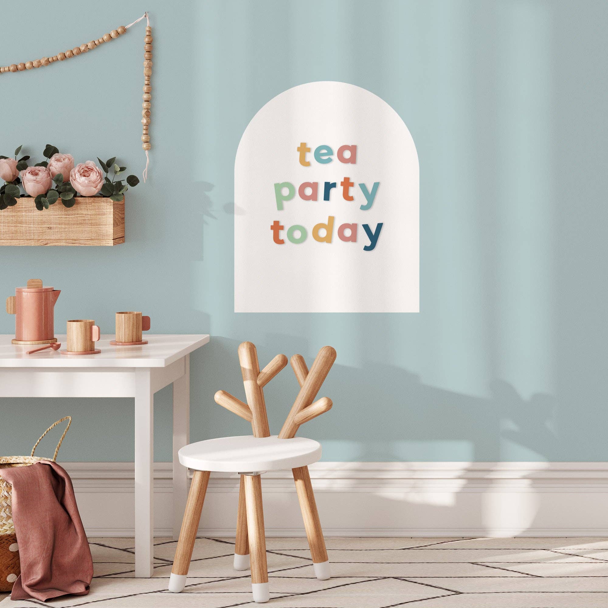 Children's room with a 'tea party today' sign, wooden chair, and small table.
