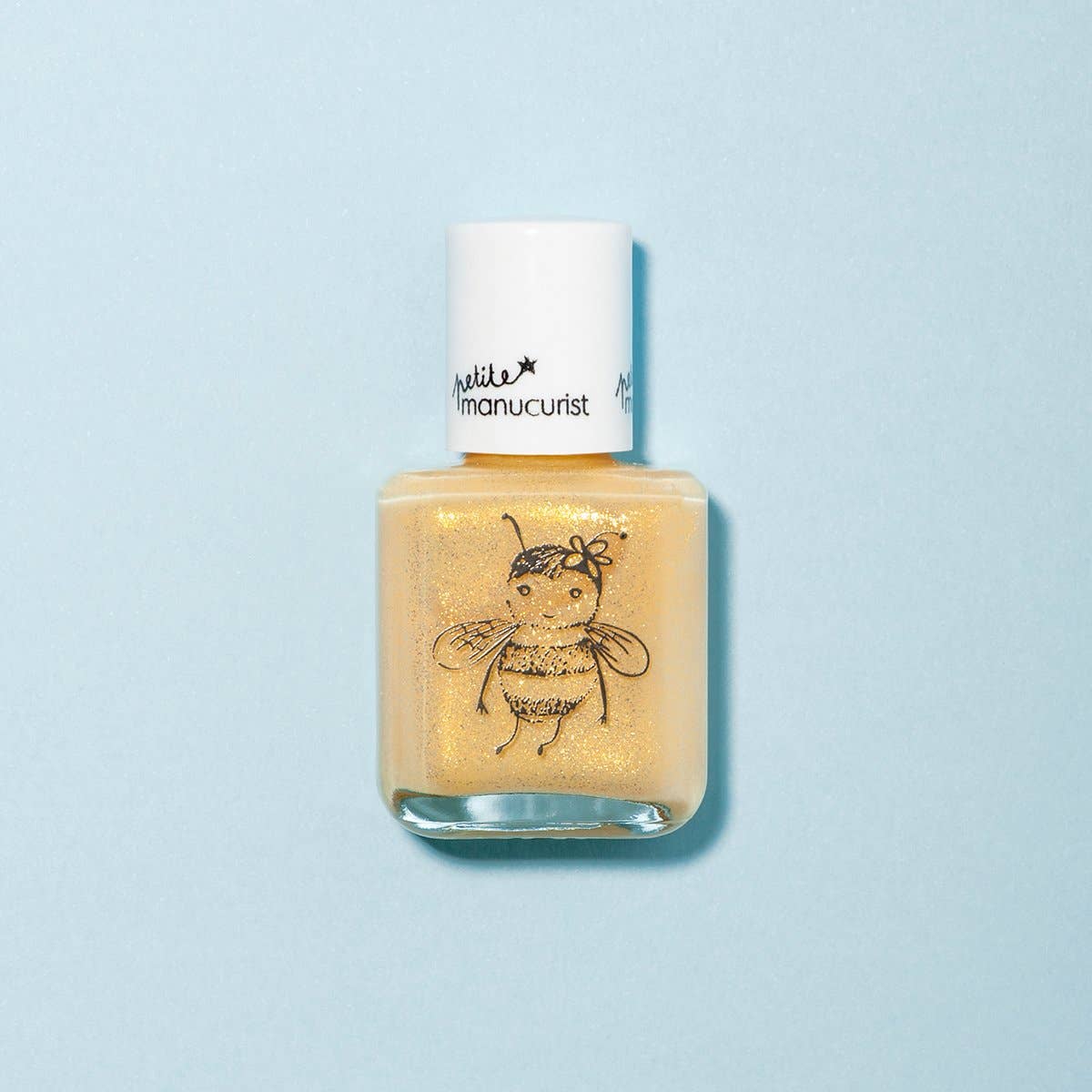 Nail polish bottle with a bee design on a light blue background
