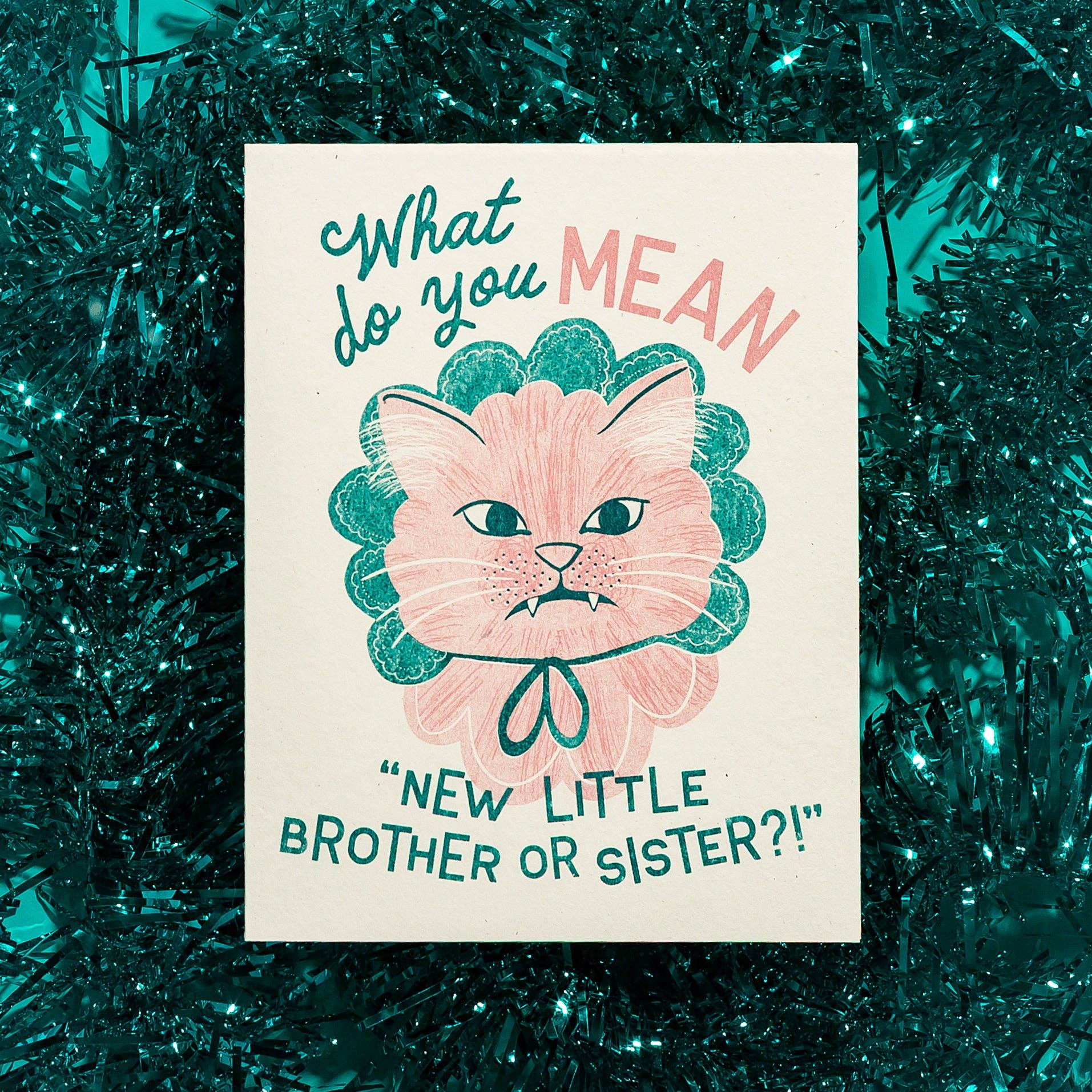 Card with a cat illustration and text on a green tinsel background