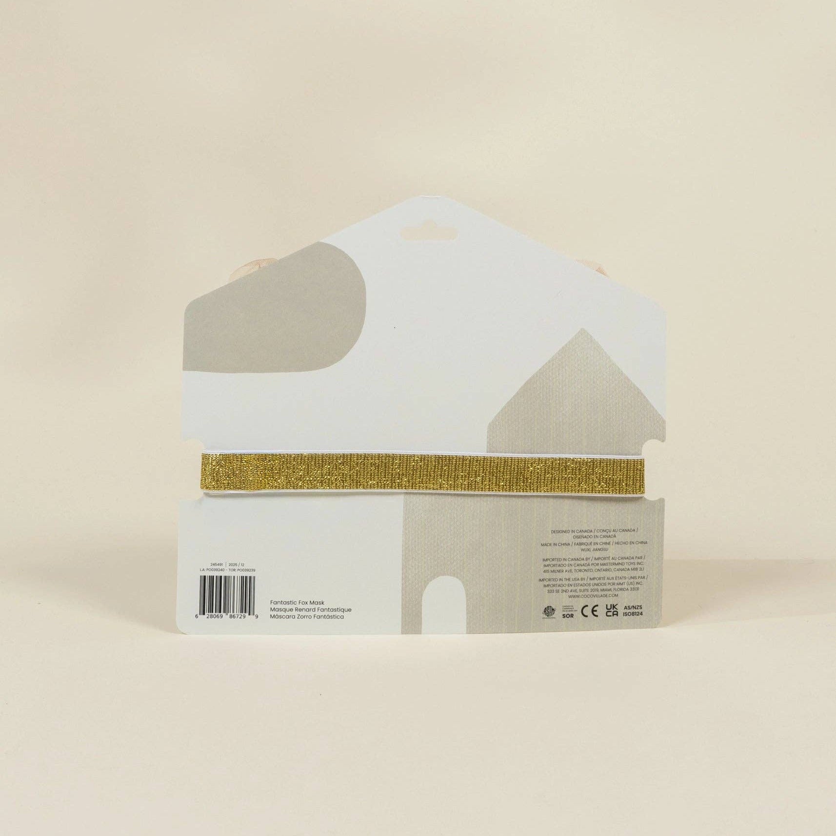 House-shaped product packaging with gold band on a beige background