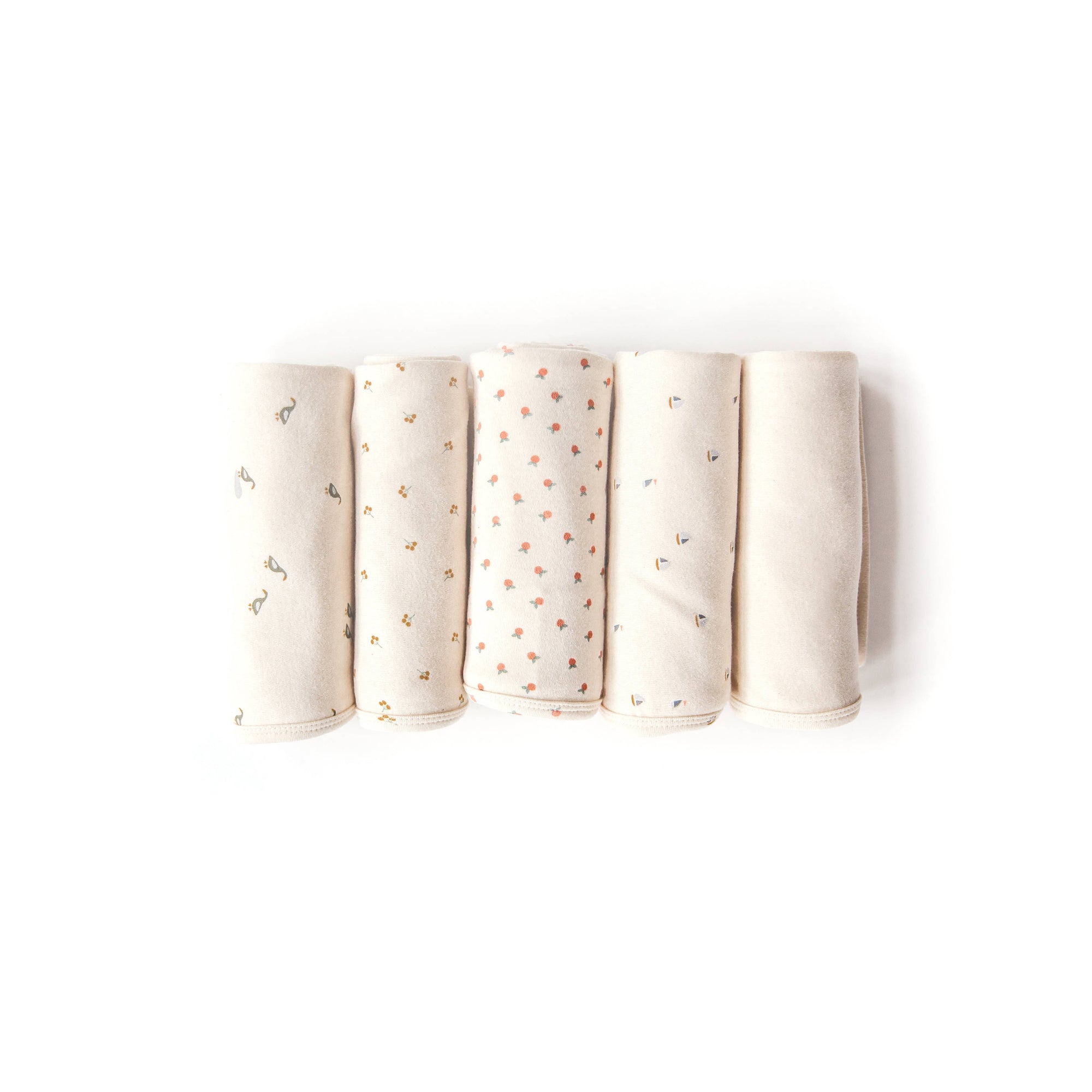 Five folded fabric swaddles with subtle patterns on a white background