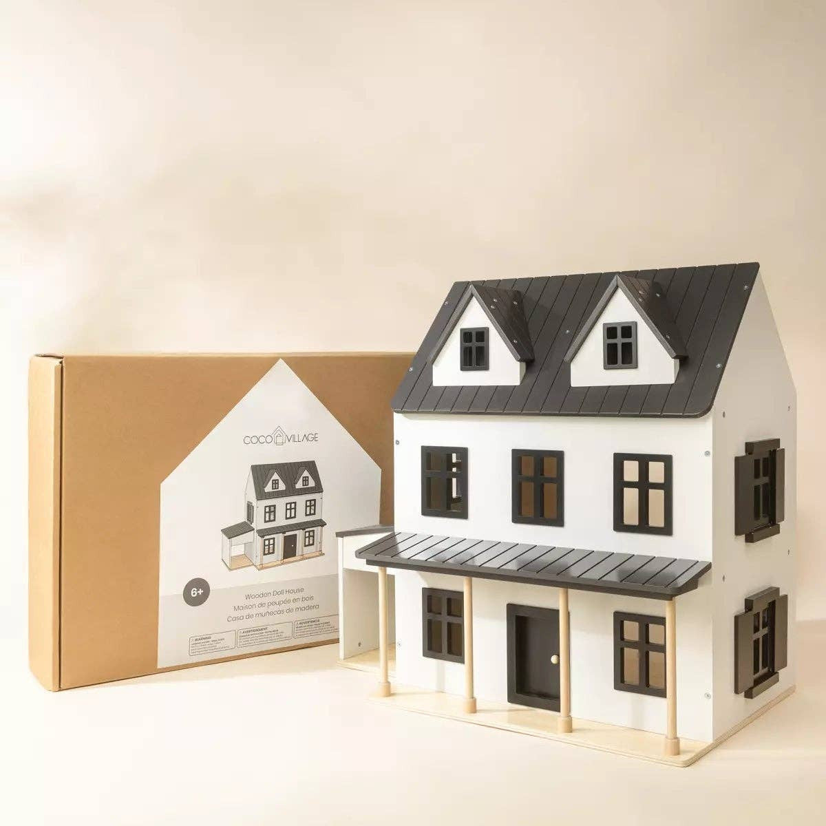 Model house with a matching packaging box on a beige background