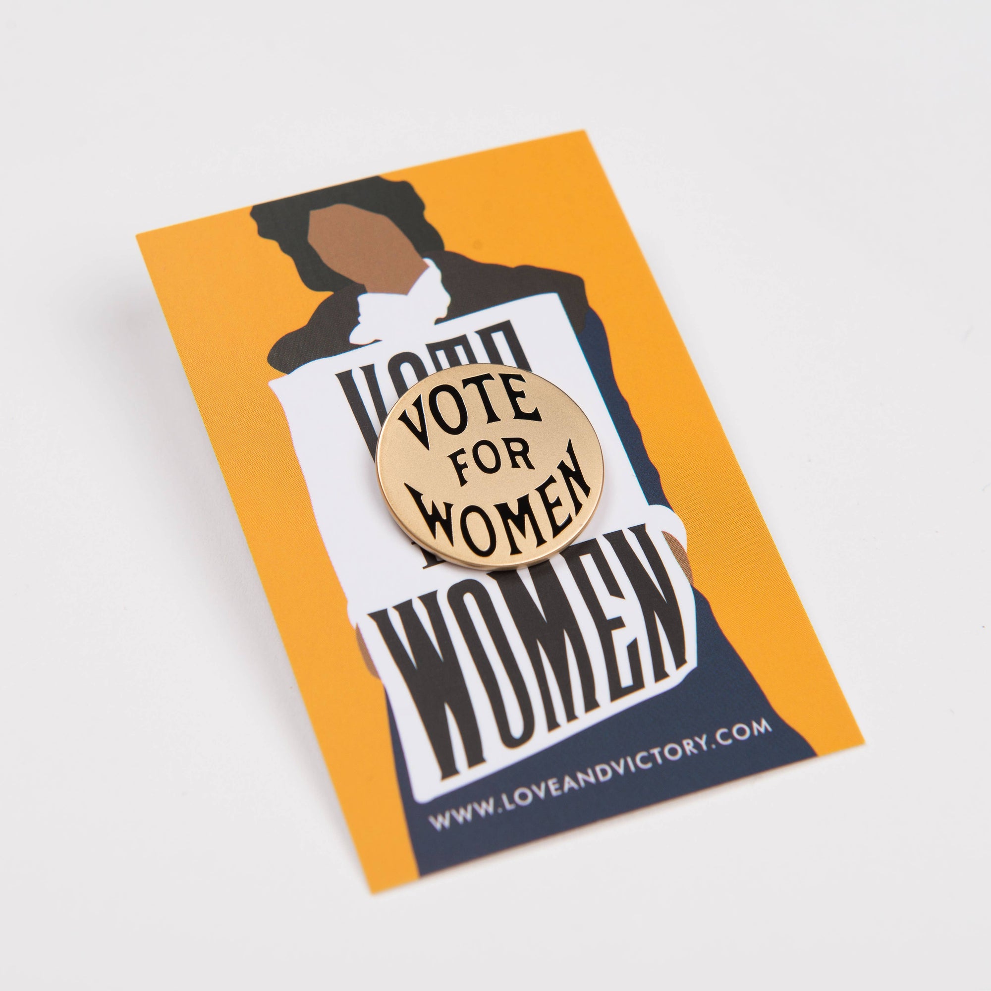 Pin with 'Vote for Women' text on a card with a woman silhouette, on a white background